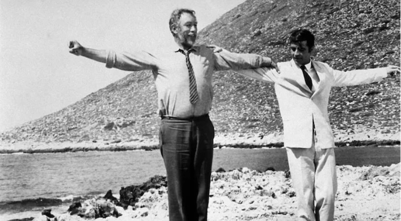Film still from Zorba the Greek (1964): two men dancing on a beach, arms outstretched